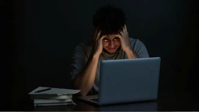 freepik__stressed-university-student-late-night-studying-la__18809.jpg