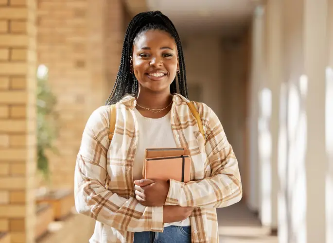 Smiling-Female-Student-Books-Hallway.jpg