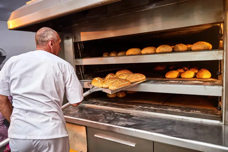 baker-taking-loaves-out-of-industrial-oven.jpg
