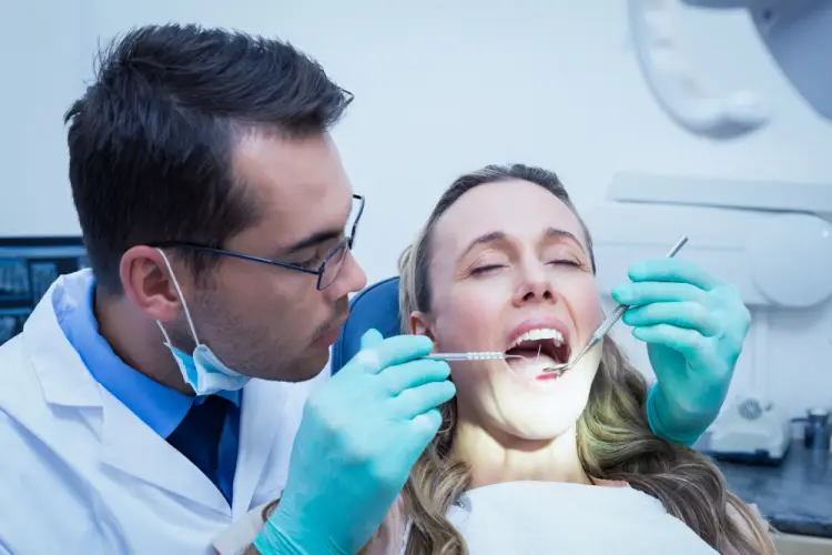 dentist-performing-dental-checkup.jpg