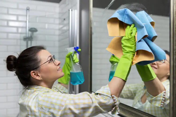 cleaning-bathroom-mirror-green-gloves.jpg