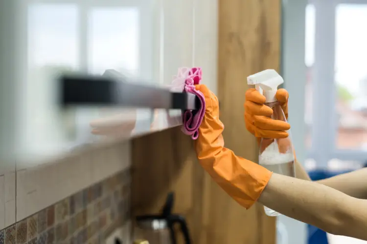 spraying-and-wiping-kitchen-surface-orange-gloves.jpg