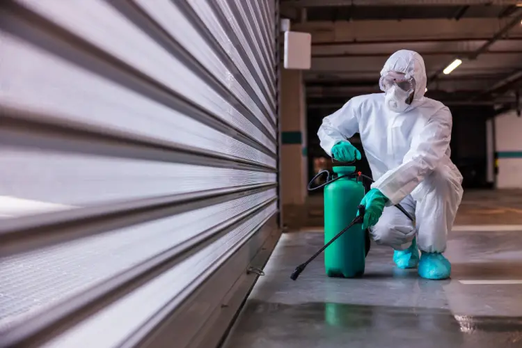 technician-spraying-outside-warehouse-door.jpg