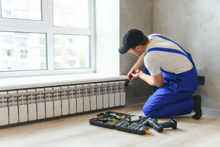 cheerful-male-worker-plumber-checking-pipes-while-installing-heating-system-apartment_255667-59278.jpg