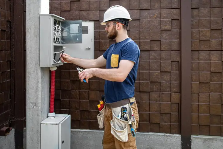 electrician-builder-work-examines-cable-connection-electrical-line-fuselage-industrial-switchboard-professional-overalls-with-electrician-s-tool_169016-8632.jpg