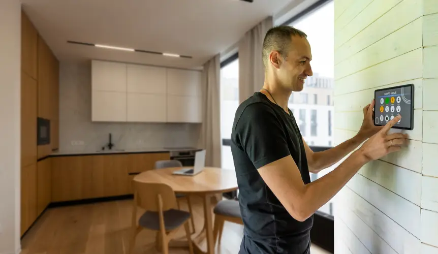 man-using-smart-home-control-panel-in-modern-kitchen.jpg