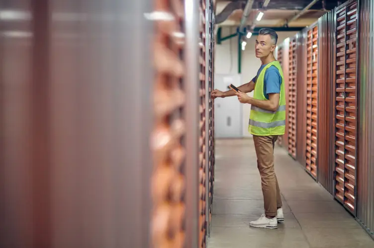 worker-in-safety-vest-checking-storage-units.jpg