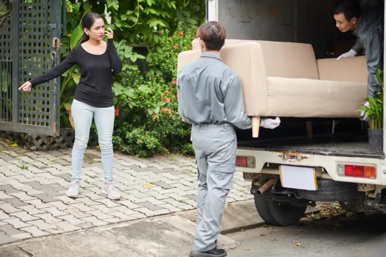 movers-loading-sofa-into-truck-with-customer-watching.jpg