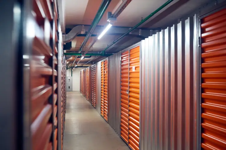 well-lit-indoor-self-storage-hallway-orange-doors.jpg