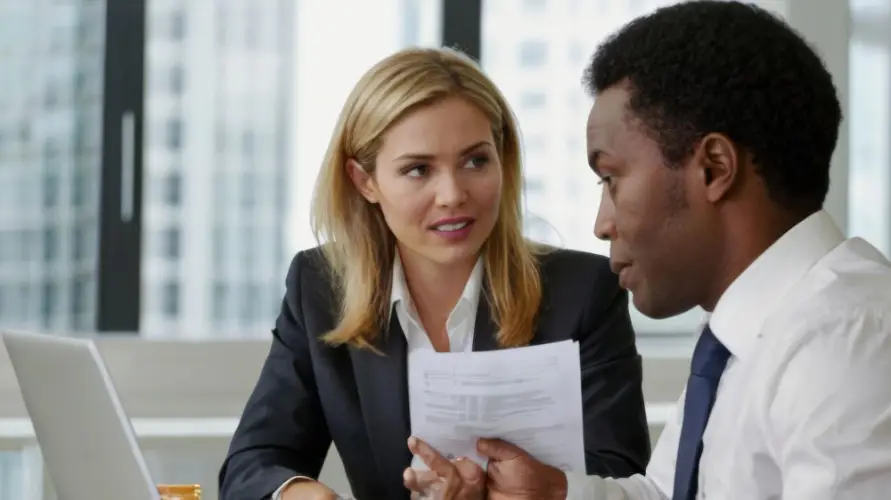 colleagues-discussing-documents-office.jpg