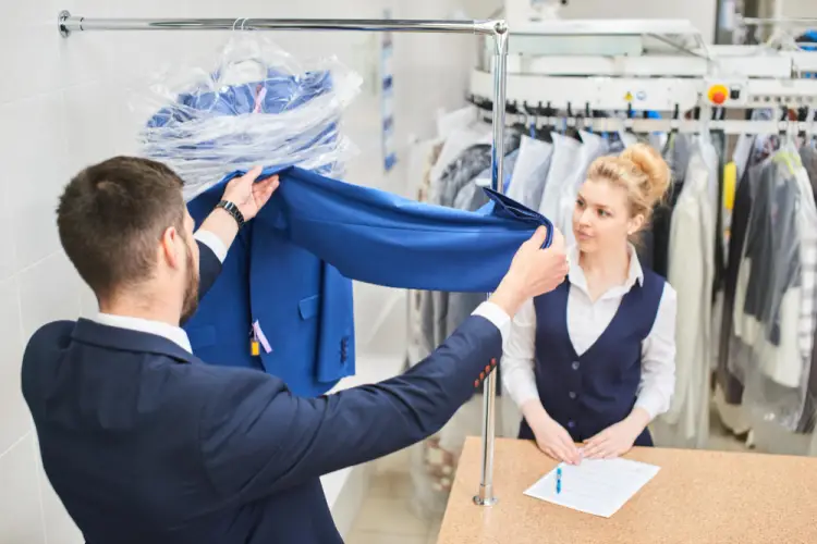 man-checking-suit-at-dry-cleaning.jpg