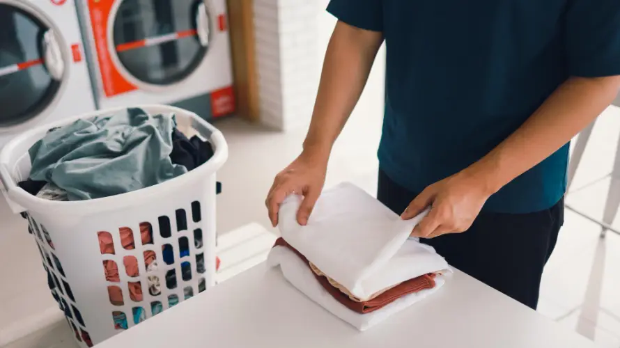 man-folding-clothes-laundromat.jpg
