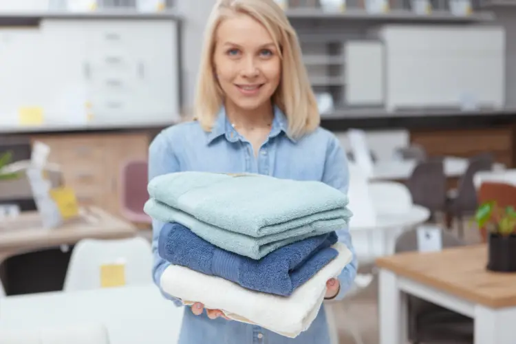 woman-holding-folded-towels-clean-laundry.jpg