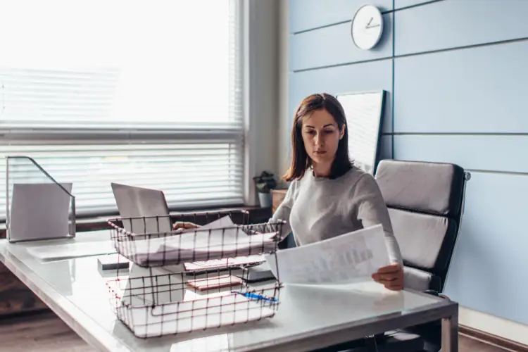 woman-reviewing-financial-reports-in-office.jpg