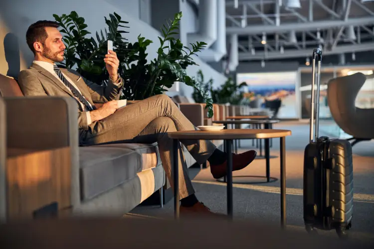 businessman-in-airport-relaxing-with-phone.jpg