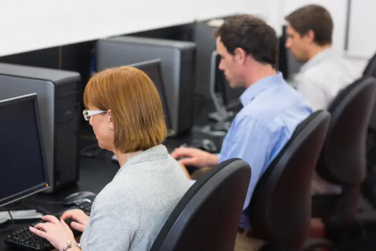 classroom-of-adults-typing-on-desktop-computers.jpg