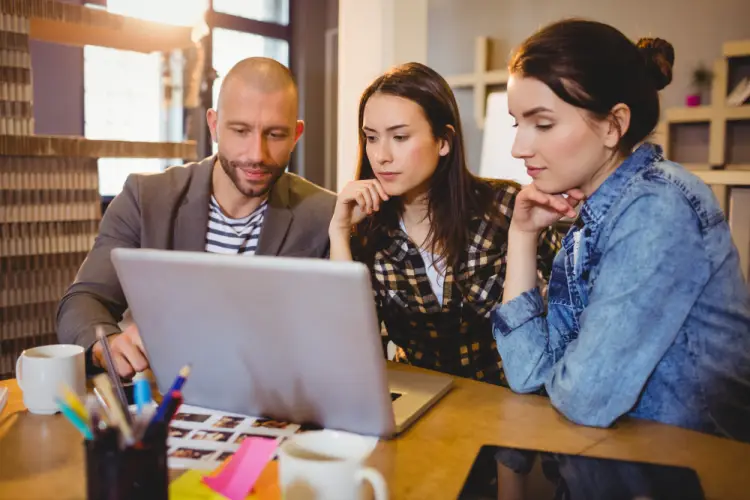 creative-team-discussing-ideas-around-laptop.jpg