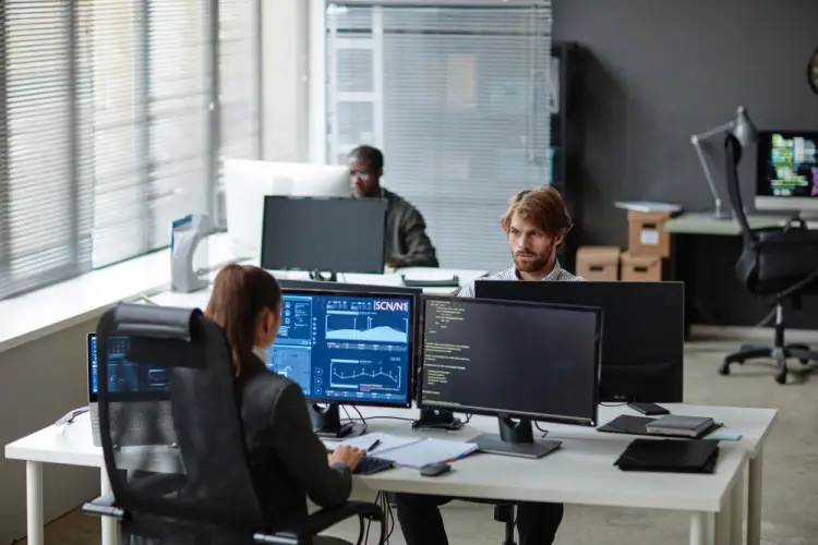 team-working-on-cybersecurity-monitors.jpg