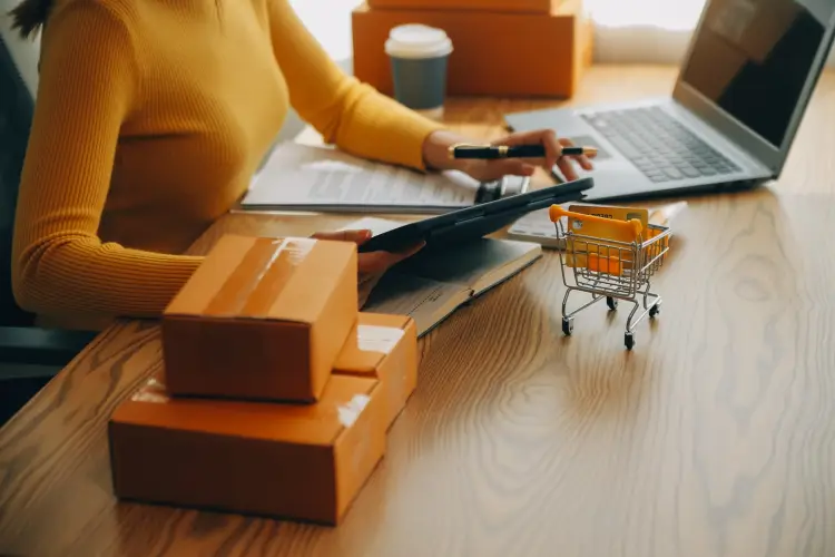 young-woman-small-business-owner-online-shopping-home-taking-note-orders-from-customers-with-mobile-phones-sme-entrepreneur-freelance-life-style-concept.jpg