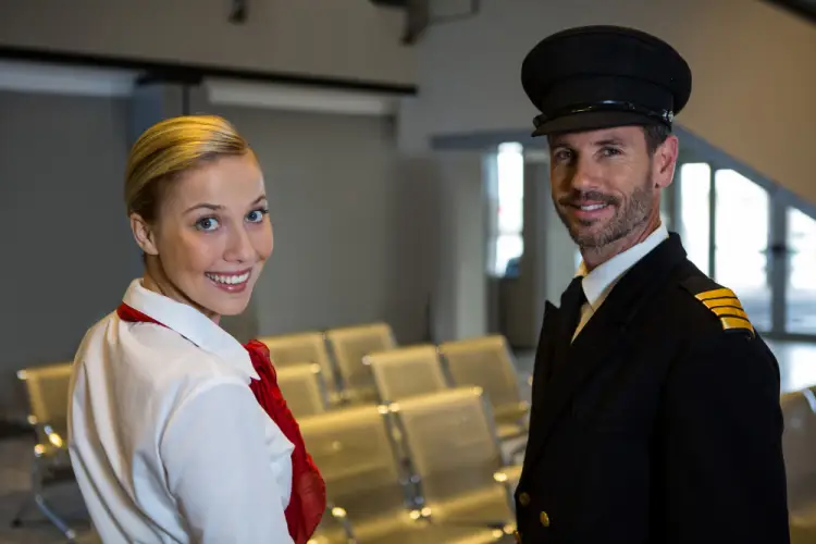pilot-and-flight-attendant-smiling-in-lounge.jpg