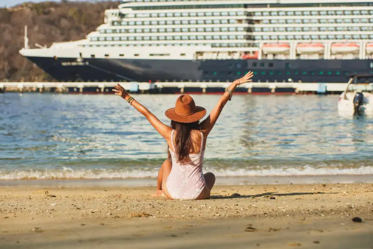 woman-on-beach-watching-cruise-ship.jpg