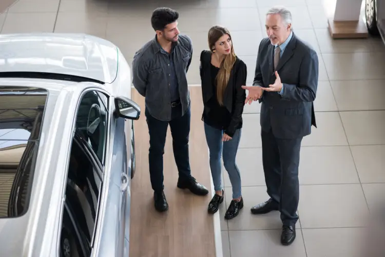 salesperson-showing-car-to-couple.jpg