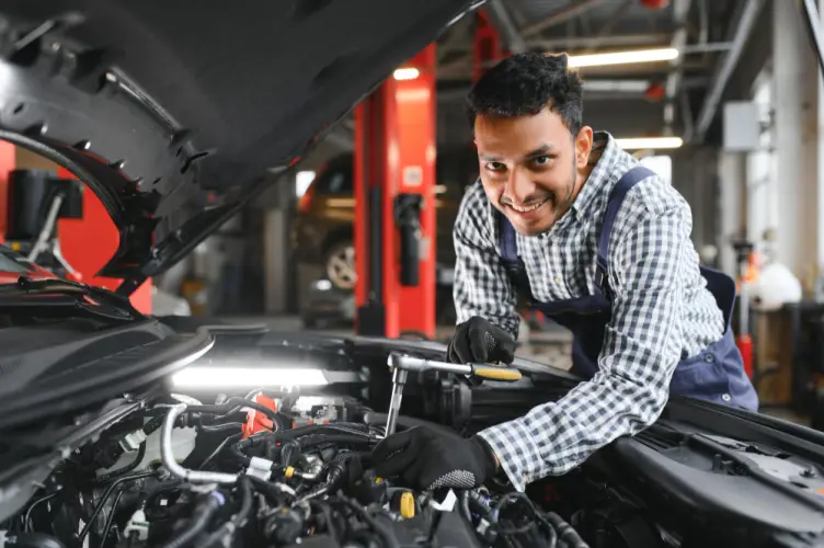 young-male-mechanic-working-on-engine-car-repair-garage.jpg