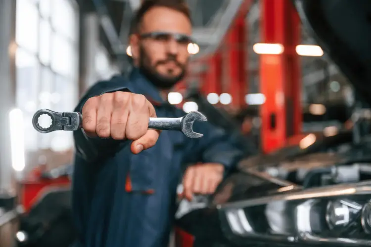 mechanic-holding-wrench-in-auto-shop.jpg
