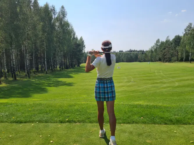 female-golfer-practicing-on-green-fairway.jpg