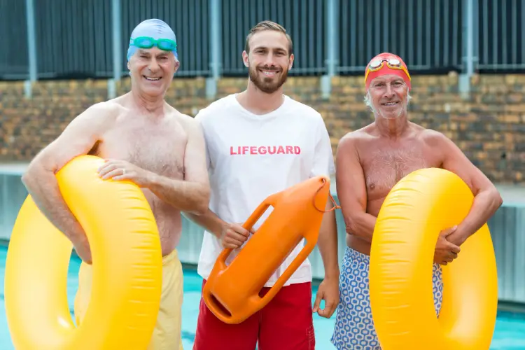 lifeguard-with-senior-swimmers-by-pool.jpg