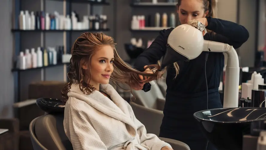 woman-in-robe-getting-hair-dried-in-modern-salon.jpg