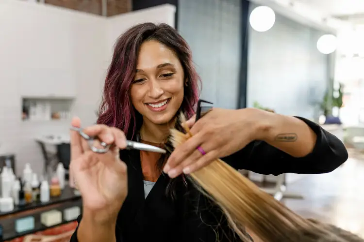 female-hair-stylist-cutting-hair.jpg