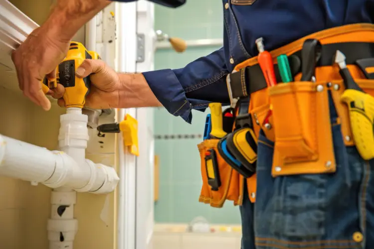 plumber-using-electric-drill-on-pipes.jpg