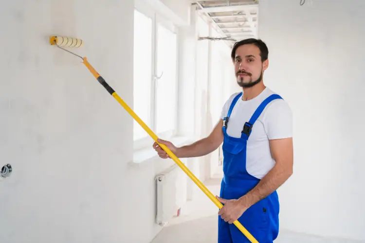worker-painting-wall-with-roller.jpg