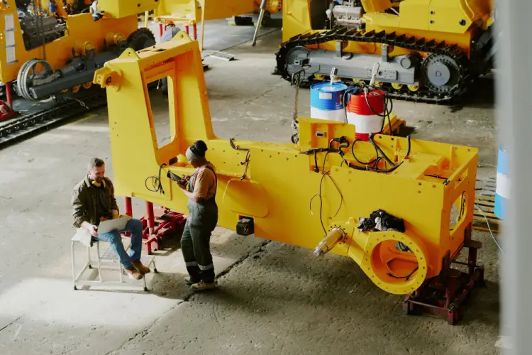 assembly-workers-heavy-equipment-parts.jpg