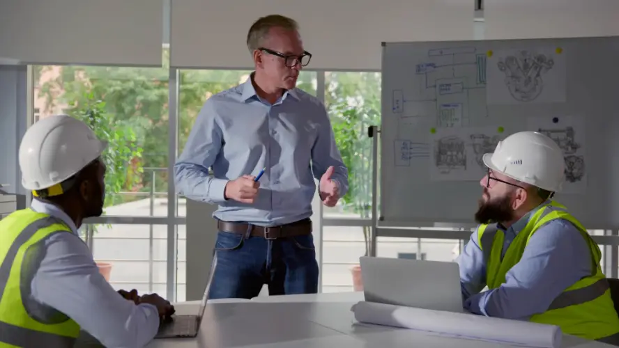 engineers-team-meeting-over-blueprints.jpg
