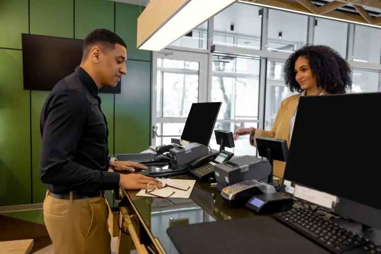 receptionist-assisting-guest-at-modern-front-desk.jpg