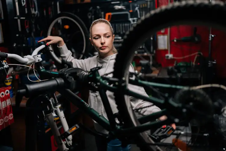 female-bike-mechanic-inspecting-bicycle.jpg