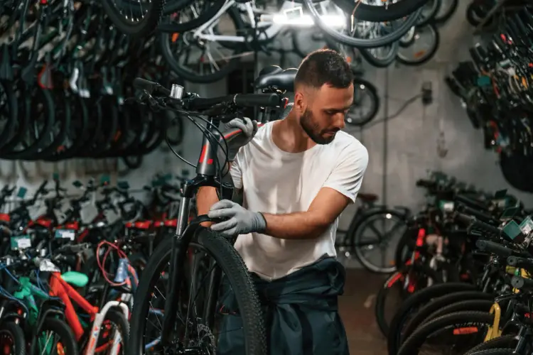 male-bike-mechanic-checking-bicycle-wheel.jpg