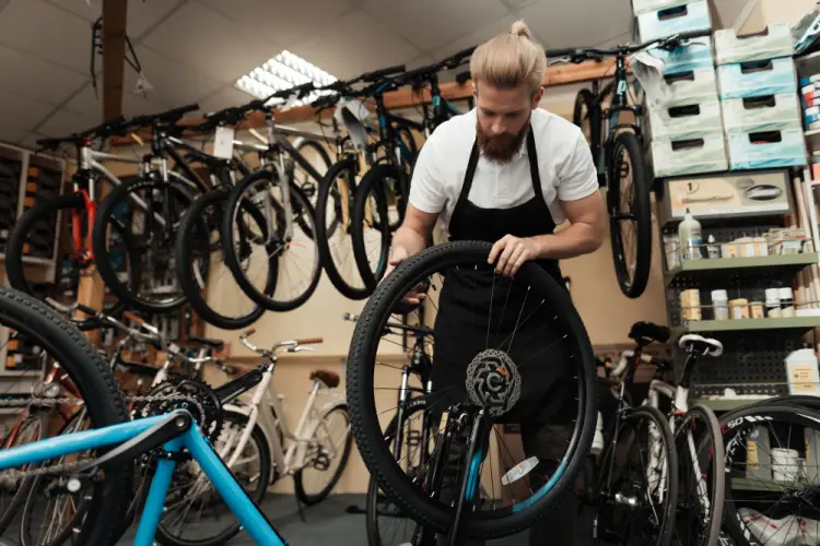 bike-mechanic-working-on-tire-in-shop.jpg