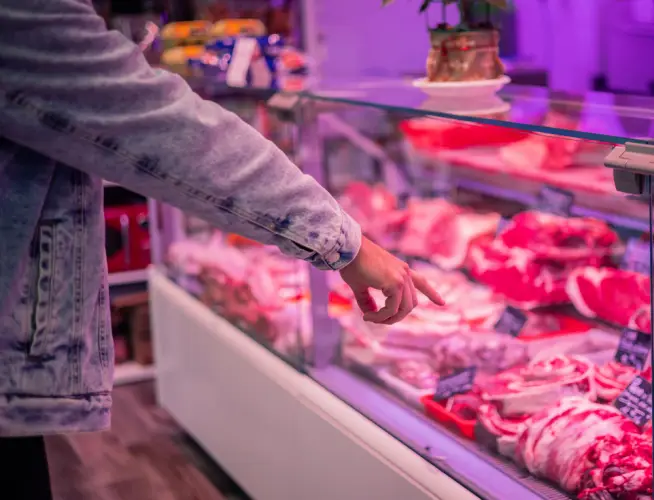 hand-pointing-at-meat-display-case.jpg