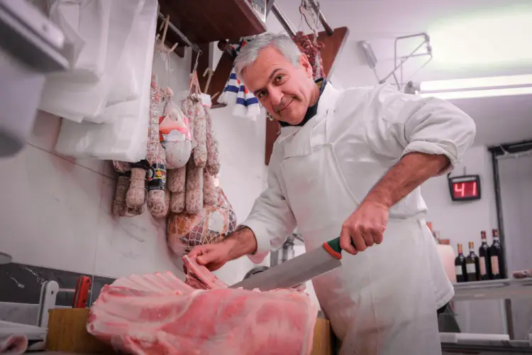senior-butcher-cutting-fresh-meat.jpg