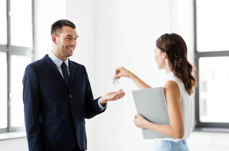 realtor-giving-key-customer-new-office.jpg