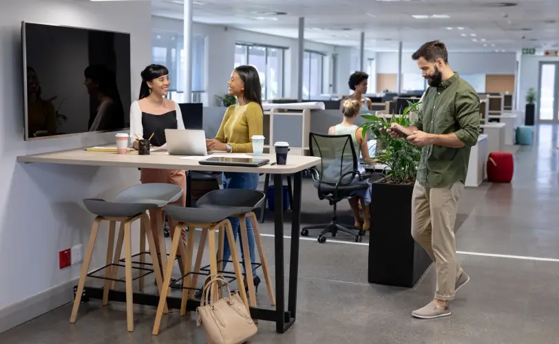 caucasian-businessman-walking-towards-biracial-businesswomen-discussing-meeting-workplace.jpg