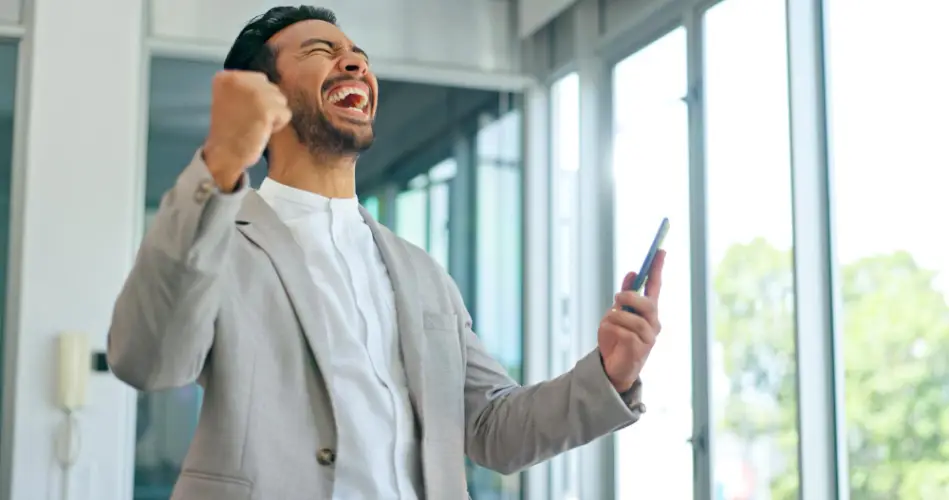 man-celebrating-financial-success-on-phone.jpg