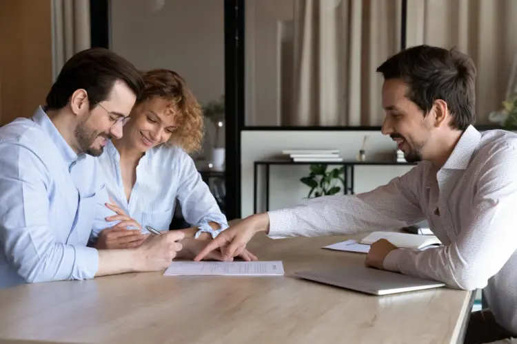 couple-signing-loan-agreement-with-advisor.jpg