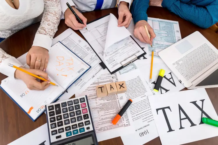 people-filing-tax-forms-with-laptop.jpg