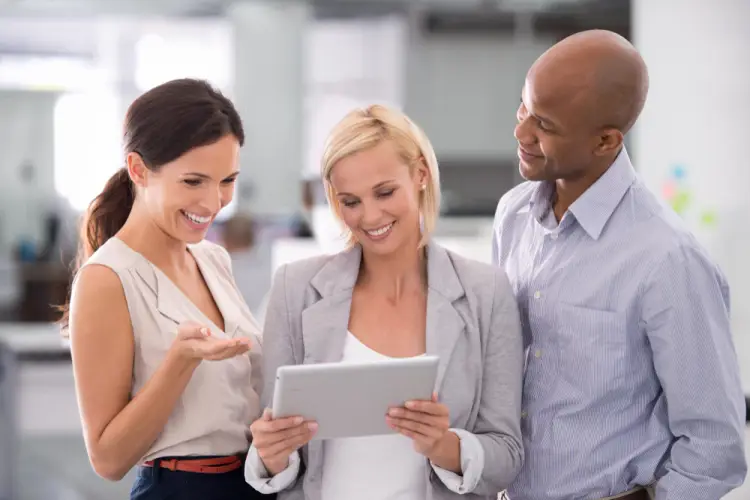 business-team-smiling-looking-at-tablet.jpg
