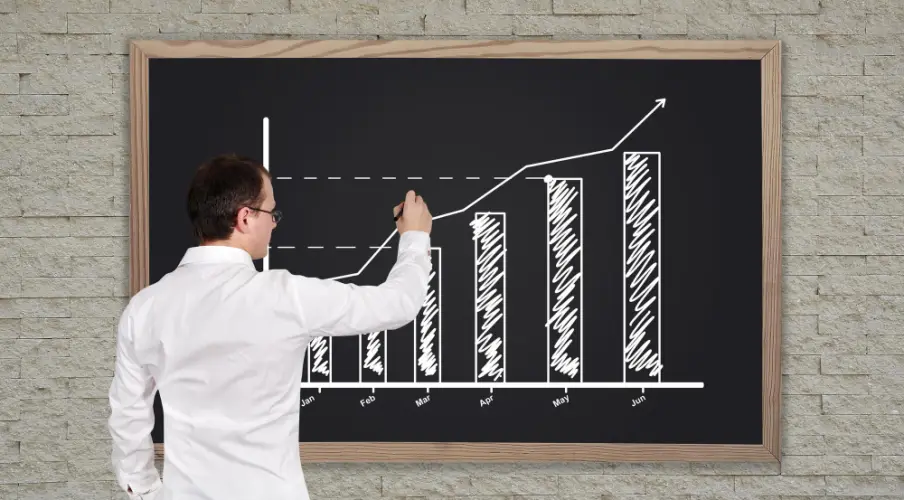 drawing-bar-chart-on-blackboard-for-monthly-progress.jpg