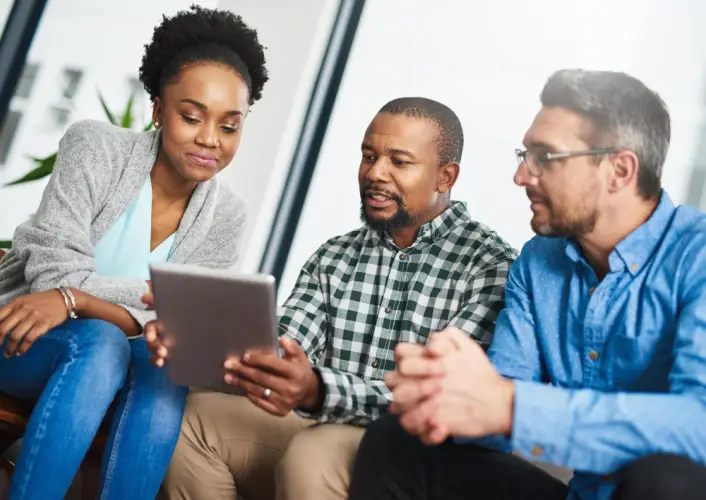 diverse-team-discussing-on-tablet.jpg